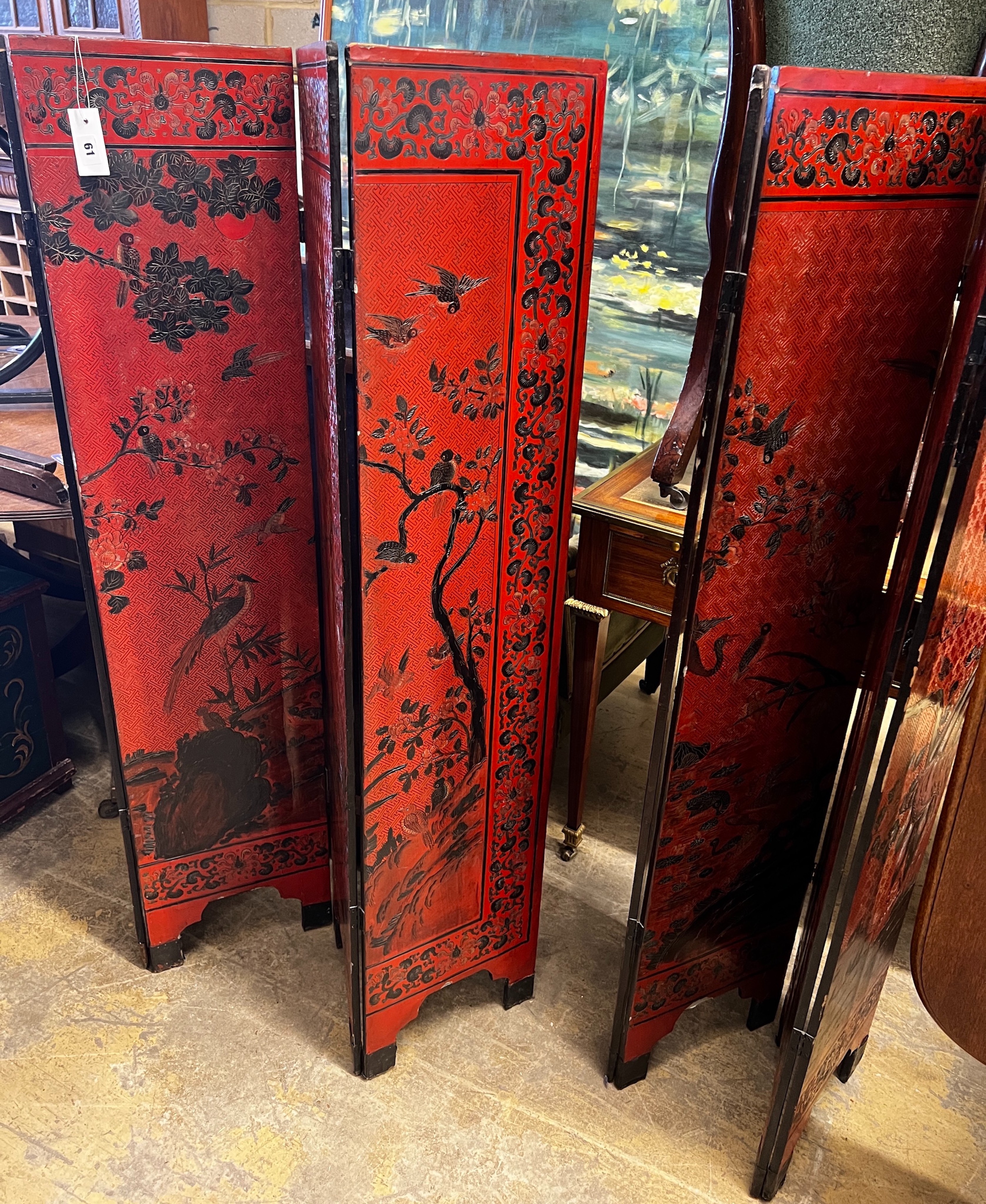 A pair of Chinese four fold lacquer screens decorated with exotic birds amongst branches, each panel width 30cm, height 141cm